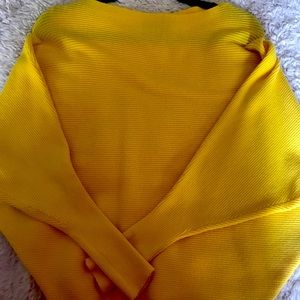 Gold batwing sleeve pullover sweater w/boatneck and narrow waist.
